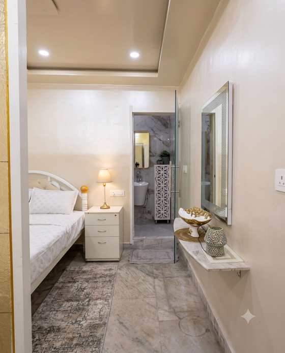 The dressing corridor of the Heritage Room, leading to a marble bathroom with a walk-in shower