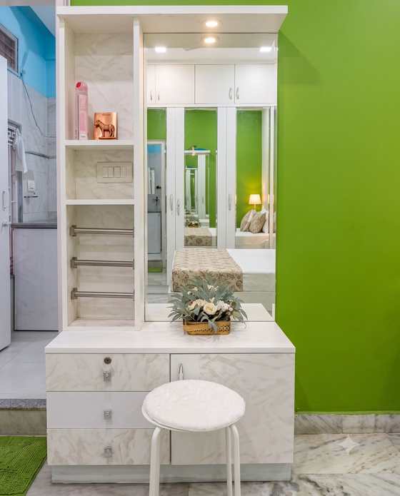 The run of mirrored fitted wardrobes facing the emerald wall in the Green Room