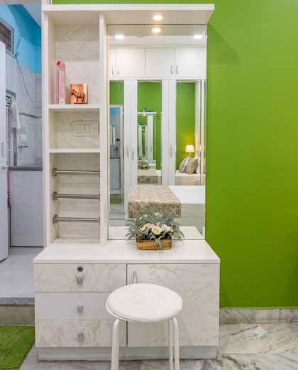 The run of mirrored fitted wardrobes facing the emerald wall in the Green Room
