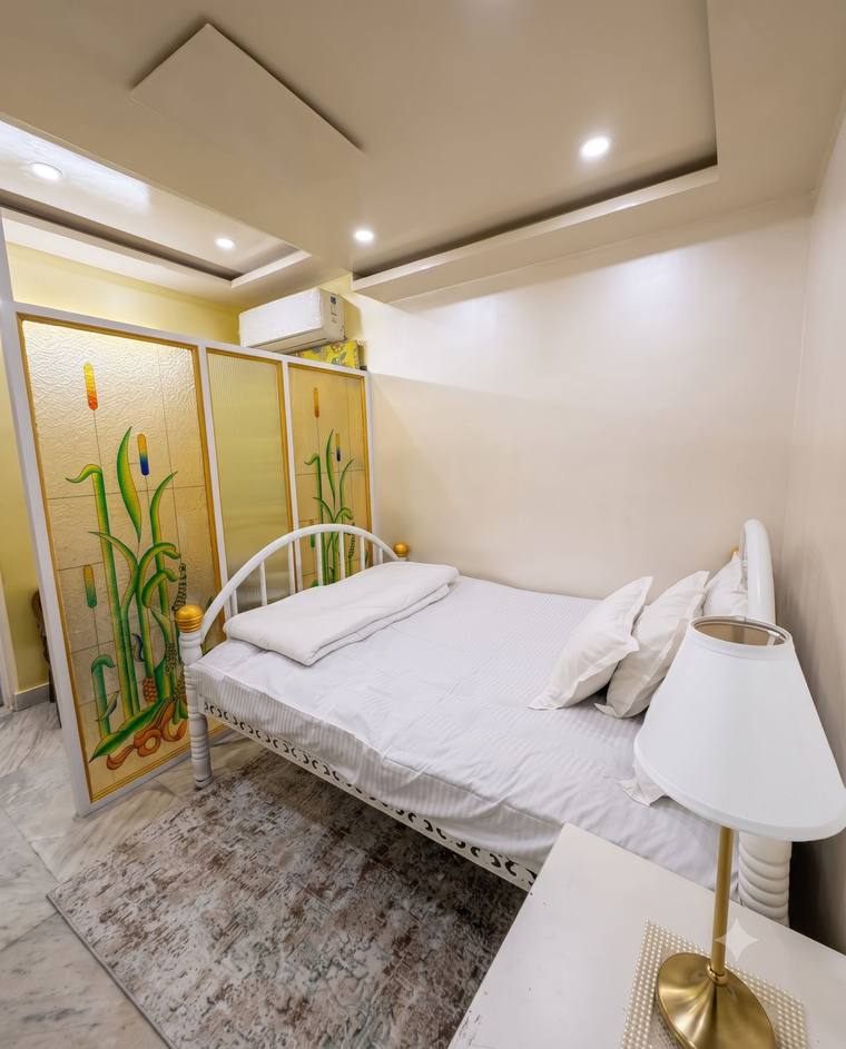 The Heritage Room at Renu'z Homestay, with a white and gold bed against ivory walls