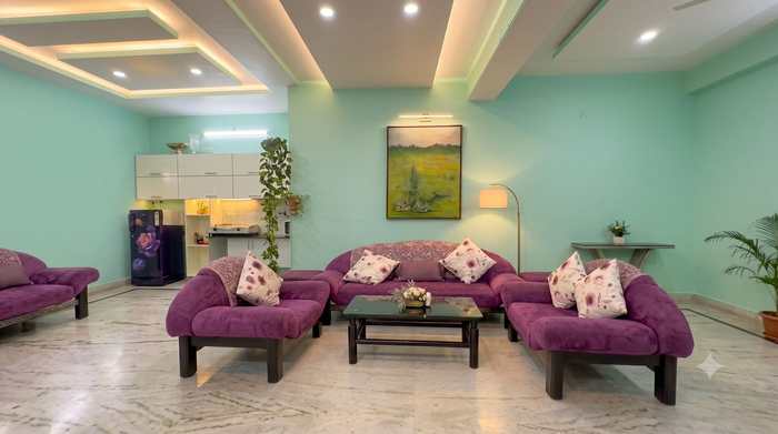 The sitting room at Renu’z Homestay, with purple sofas on a marble floor