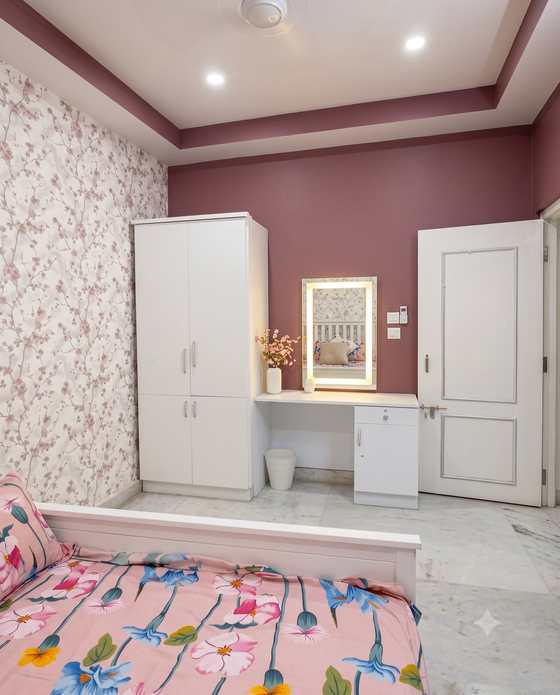 The dressing table with a lit mirror in the Rose Room, beside lace curtains