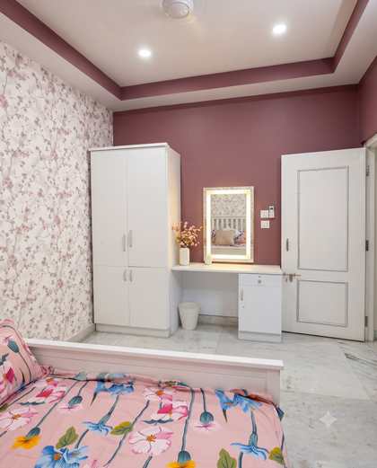 The dressing table with a lit mirror in the Rose Room, beside lace curtains
